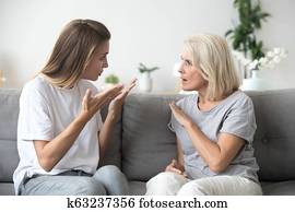 Angry young woman having disagreement with annoyed old mother Angry young woman having disagreement with annoyed old mother