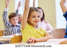 group of school kids with notebooks in classroom group of school kids with notebooks in classroom