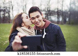 Loving teenage couple taking self portrait