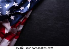 Happy Veterans Day. American flags veterans against a blackboard background. Happy Veterans Day. American flags veterans against a blackboard background.