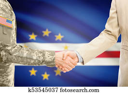 USA military man in uniform and civil man in suit shaking hands with adequate national flag on background - Cape Verde
