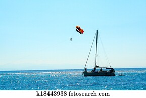 Colored parachute over a sailboat