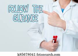 Writing note showing Follow The Guidance. Business photo showcasing controlling a course of projectile by builtin mechanism Empty sticker paper accessories smartphone with medical gloves on.