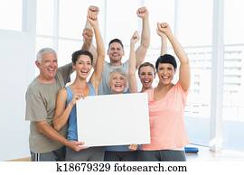 Portrait of happy fit people holding blank board
