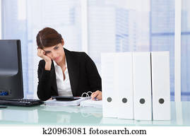 Worried Businesswoman At Desk