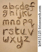 Alphabet written in sand.