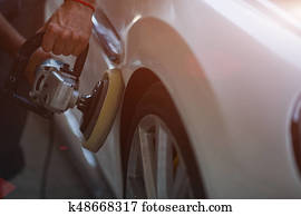 Car detailing series : Worker waxing white car door Car detailing series : Worker waxing white car door