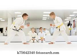 Children learning to fight at karate lesson