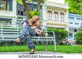 Mom and son in the background of Old houses in the Old Town of Georgetown, Penang, Malaysia