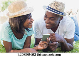 Happy couple lying in garden togeth