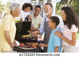 Family Enjoying A Barbeque Family Enjoying A Barbeque