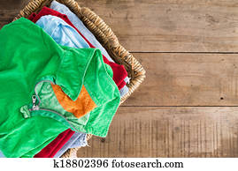 Clean unironed summer clothes in a laundry basket