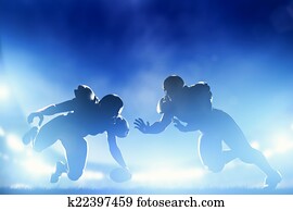 American football players in game, touchdown. Stadium lights American football players in game, touchdown. Stadium lights