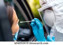 Asian woman Drive Thru COVID-19 testing with PPE medical staff Asian woman Drive Thru COVID-19 testing with PPE medical staff