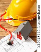 Model Home with Helmet, Stethoscope and Blueprint