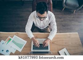 Top above high angle view of his he nice attractive skilled man employee writing email preparing launching start-up project IT at modern loft industrial style interior work place station