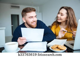 Couple calculating their bills at home