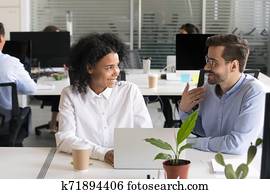 Friendly mentor explaining African American intern new project Friendly mentor explaining African American intern new project