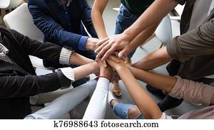 Top view hands stacked together as symbol of teambuilding Top view hands stacked together as symbol of teambuilding