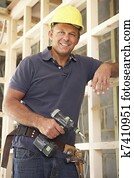 Construction Worker Building Timber Frame In New Home