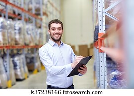 happy businessman with clipboard at warehouse happy businessman with clipboard at warehouse