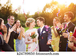 Newlyweds with guest on their garden party
