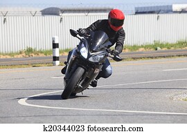young man riding motorcycle in asphalt road curve use for male a young man riding motorcycle in asphalt road curve use for male a