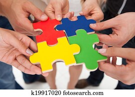 Businesspeople Joining Puzzle Pieces