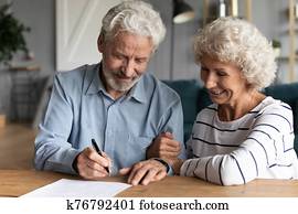 60s elderly spouses at lawyer office sign marriage contract 60s elderly spouses at lawyer office sign marriage contract