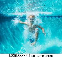 Young Boy Diving Underwater in Swimming Pool Young Boy Diving Underwater in Swimming Pool