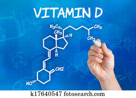 Hand with pen drawing the chemical formula of vitamin d Hand with pen drawing the chemical formula of vitamin d