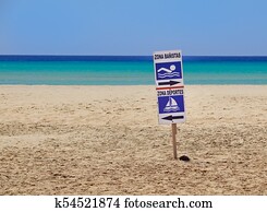 sign of bathing area on the beach for the safety of bathers compared to boats . 