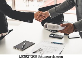 Businessman handshake businesswoman in office. Businessman handshake businesswoman in office.