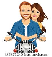 Young happy couple riding a motorcycle Young happy couple riding a motorcycle