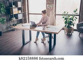 Portrait of nice attractive focused successful hardworking businesslady top executive director sitting in chair overworking at modern industrial brick loft style interior work place station open space