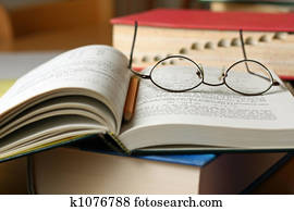 Text books on table with glasses and pencil Text books on table with glasses and pencil