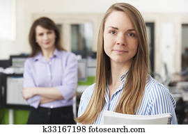 Young Businesswoman With Mentor In Office