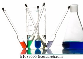 red, blue and green retorts with liquids, white background, close-up