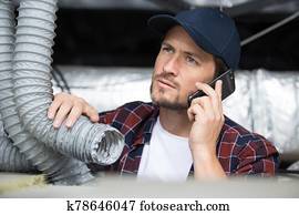 young repairman contractor repairing heating panel young repairman contractor repairing heating panel