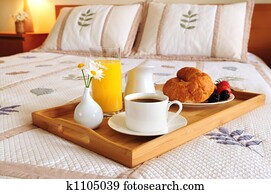 Breakfast on a bed in a hotel room Breakfast on a bed in a hotel room