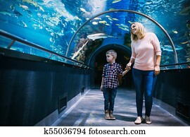 Mother and her child watching sea life