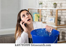 Woman Calling Plumber For Water Leakage At Home Woman Calling Plumber For Water Leakage At Home