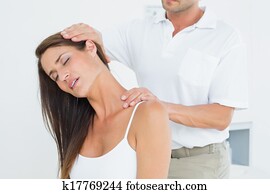 Male chiropractor doing neck adjust Male chiropractor doing neck adjust