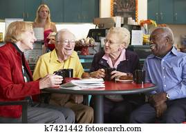 Senior adults having morning tea together