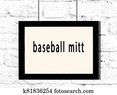 Black frame hanging on white brick wall with inscription baseball mitt