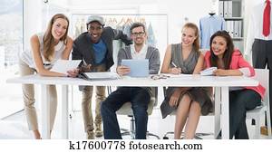 Fashion designers discussing designs Fashion designers discussing designs