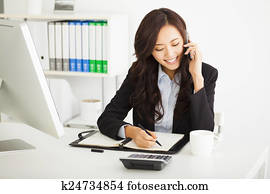 happy young businesswoman working in the office