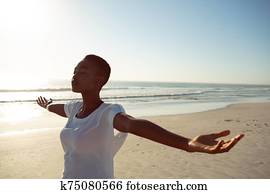 Woman performing yoga on the beach Woman performing yoga on the beach