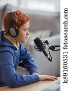 Teenage Boy Speaking to Microphone Side View