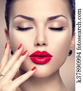Beautiful fashion woman model face portrait with red lipstick and red nails Beautiful fashion woman model face portrait with red lipstick and red nails